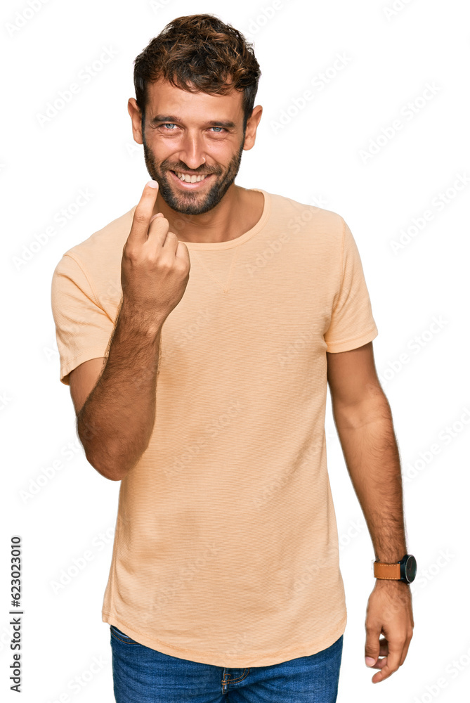 Handsome young man with beard wearing casual tshirt beckoning come here gesture with hand inviting welcoming happy and smiling Handsome young man with beard wearing casual tshirt beckoning come here gesture with hand inviting welcoming happy and smiling