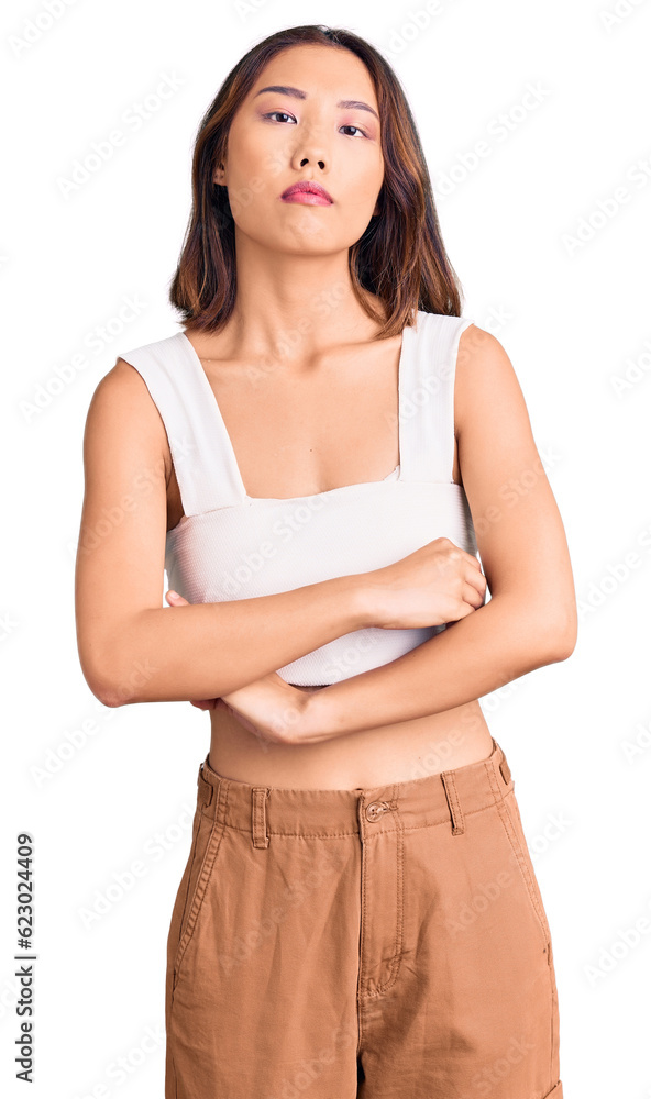 Young beautiful chinese girl wearing casual clothes relaxed with serious expression on face. simple and natural looking at the camera. Young beautiful chinese girl wearing casual clothes relaxed with serious expression on face. simple and natural looking at the camera.