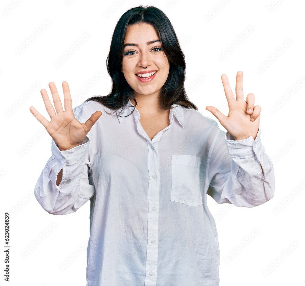 Beautiful hispanic woman wearing casual white shirt showing and pointing up with fingers number eight while smiling confident and happy. Beautiful hispanic woman wearing casual white shirt showing and pointing up with fingers number eight while smiling confident and happy.