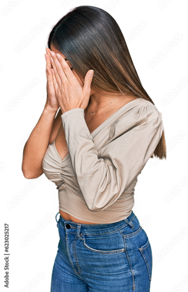 Young hispanic woman wearing casual clothes with sad expression covering face with hands while crying. depression concept. Young hispanic woman wearing casual clothes with sad expression covering face with hands while crying. depression concept.