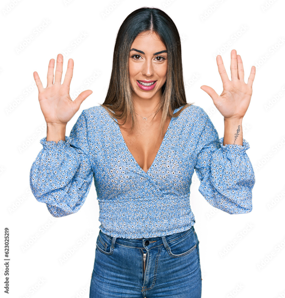 Young hispanic woman wearing casual clothes showing and pointing up with fingers number ten while smiling confident and happy. Young hispanic woman wearing casual clothes showing and pointing up with fingers number ten while smiling confident and happy.