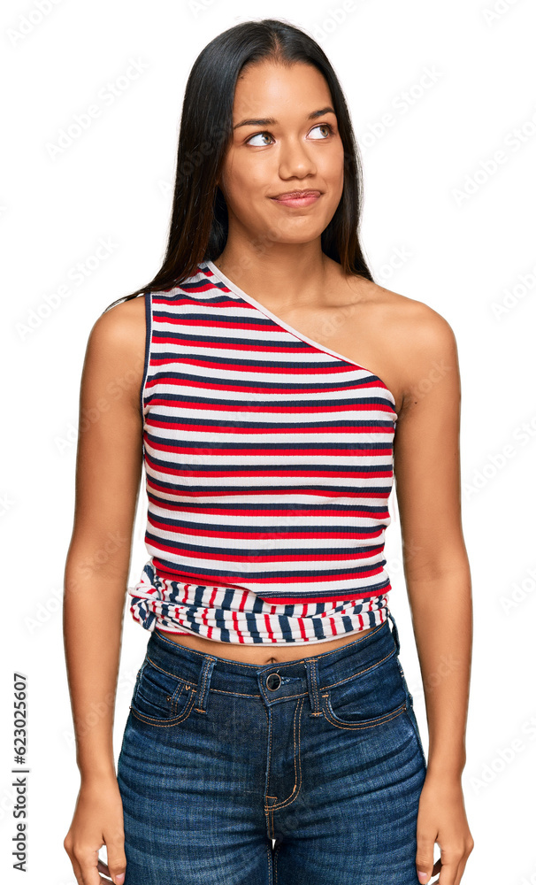 Fototapeta premium Beautiful hispanic woman wearing casual clothes smiling looking to the side and staring away thinking.