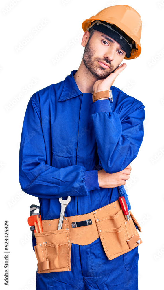 Young hispanic man wearing worker uniform thinking looking tired and bored with depression problems with crossed arms. Young hispanic man wearing worker uniform thinking looking tired and bored with depression problems with crossed arms.