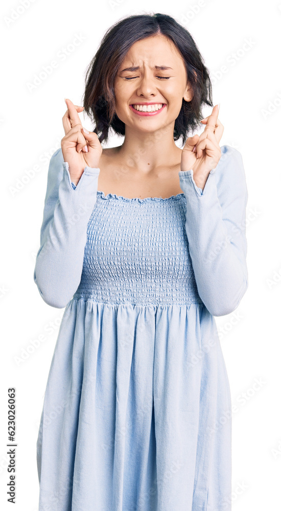 Young beautiful girl wearing casual clothes gesturing finger crossed smiling with hope and eyes closed. luck and superstitious concept. Young beautiful girl wearing casual clothes gesturing finger crossed smiling with hope and eyes closed. luck and superstitious concept.