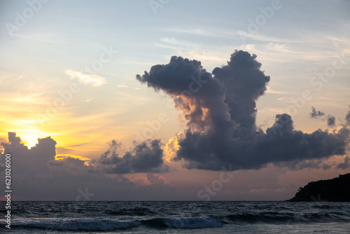 Gorgeous bird shaped clouds on the coast of Phuket island at sunset time, Thailand