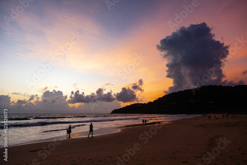 Beautiful clouds on the coast of Phuket island at sunset time with people, Thailand