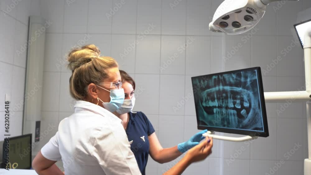 Dentist hand explore study teeth mouth cavity xray on monitor describe therapy to patient at