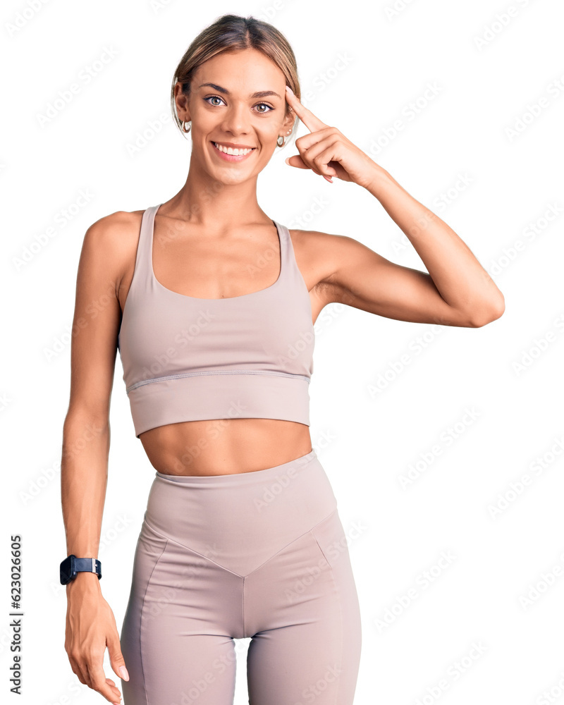 Beautiful caucasian woman wearing sportswear smiling pointing to head with one finger, great idea or thought, good memory Beautiful caucasian woman wearing sportswear smiling pointing to head with one finger, great idea or thought, good memory