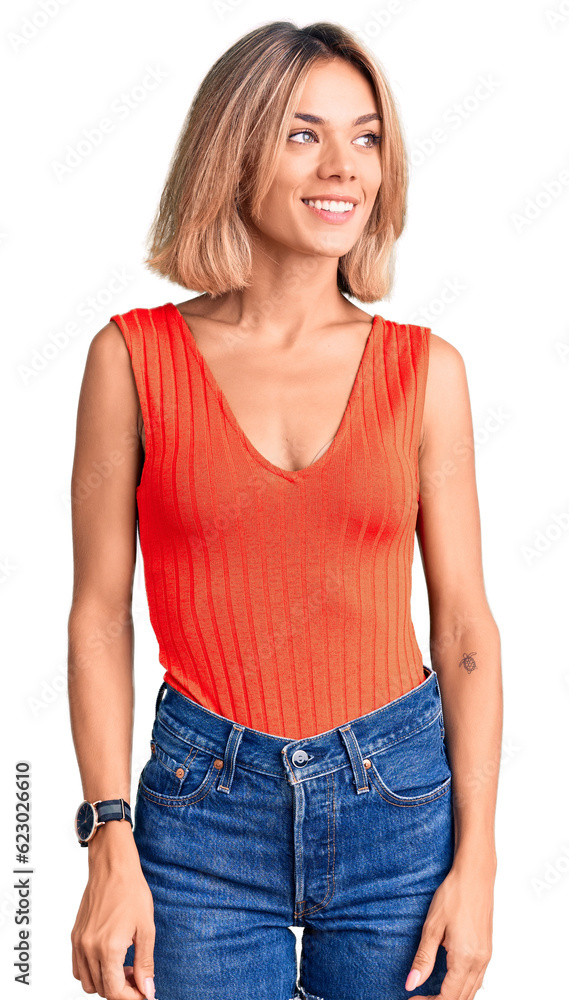 Beautiful caucasian woman wearing casual clothes looking away to side with smile on face, natural expression. laughing confident. Beautiful caucasian woman wearing casual clothes looking away to side with smile on face, natural expression. laughing confident.
