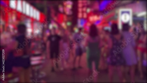 Blurred background video of tourists walking at Soi Cowboy, famous nightlife landmark. Sexy and beautiful girls at red light district, Bangkok, Thailand