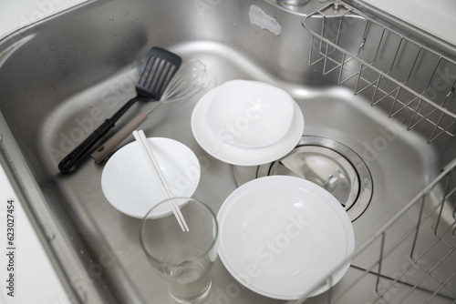 A picture of dishwashing, the number one annoying household chore Negative images such as rising water rates A clean and shiny kitchen sink after cleaning photo