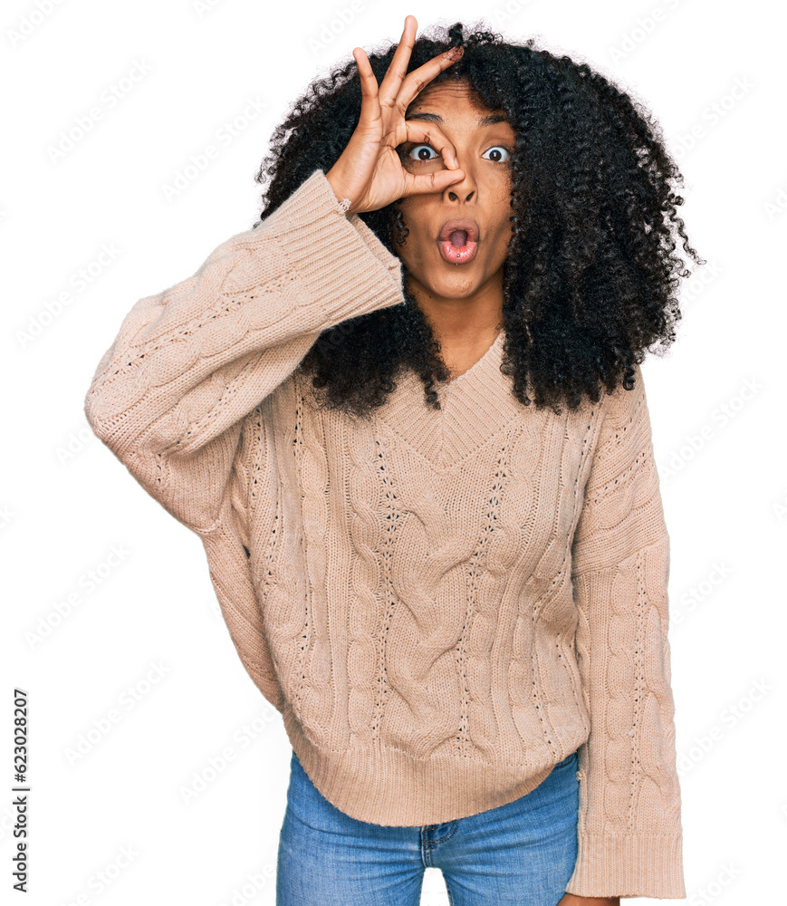 Young african american girl wearing casual clothes doing ok gesture shocked with surprised face, eye looking through fingers. unbelieving expression. Young african american girl wearing casual clothes doing ok gesture shocked with surprised face, eye looking through fingers. unbelieving expression.