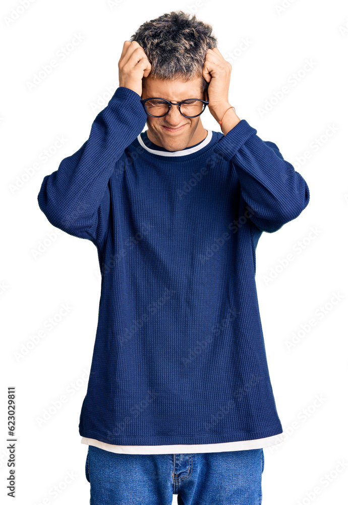 Young handsome man wearing casual clothes and glasses suffering from headache desperate and stressed because pain and migraine. hands on head. Young handsome man wearing casual clothes and glasses suffering from headache desperate and stressed because pain and migraine. hands on head.