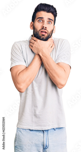 Young handsome man with beard wearing casual polo shouting and suffocate because painful strangle. health problem. asphyxiate and suicide concept.
