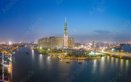 Aerial view of a Ho Chi Minh City, Vietnam with development buildings, transportation, energy power infrastructure. Financial and business centers. Sunset to night.