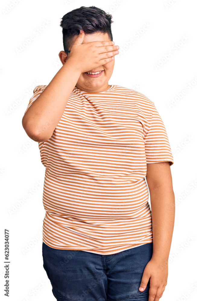 Little boy kid wearing casual clothes and glasses smiling and laughing with hand on face covering eyes for surprise. blind concept. Little boy kid wearing casual clothes and glasses smiling and laughing with hand on face covering eyes for surprise. blind concept.