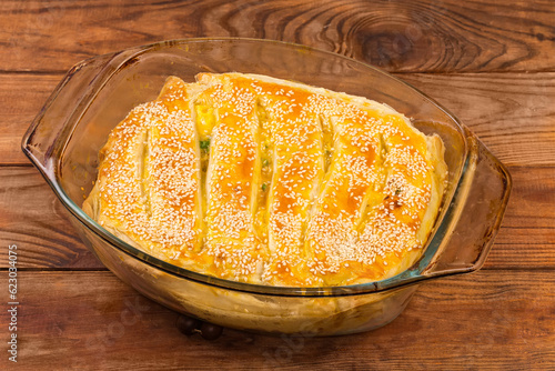 Pie with savory fish filling in glass casserole pan