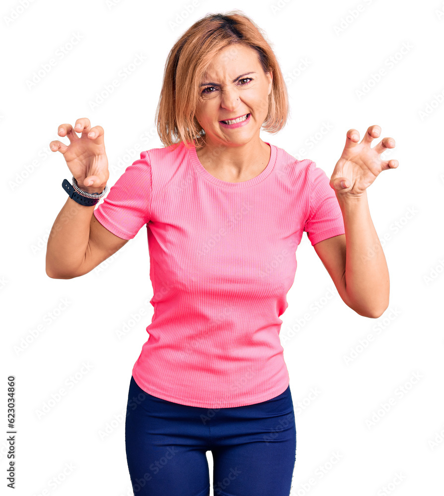 Obraz premium Young blonde woman wearing sportswear smiling funny doing claw gesture as cat, aggressive and sexy expression