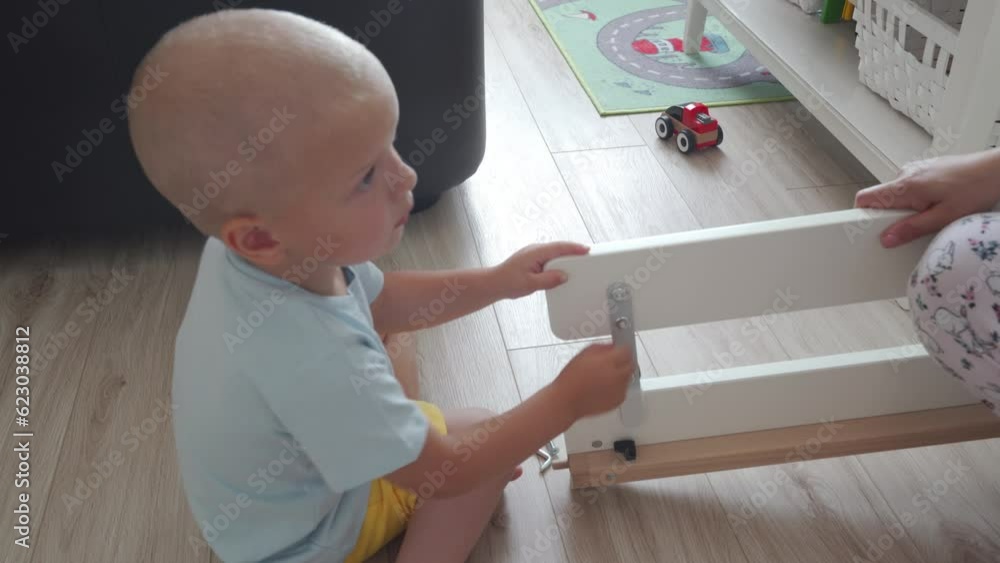 mother and child assembling new children bed for grown up baby mother and child assembling new children bed for grown up baby