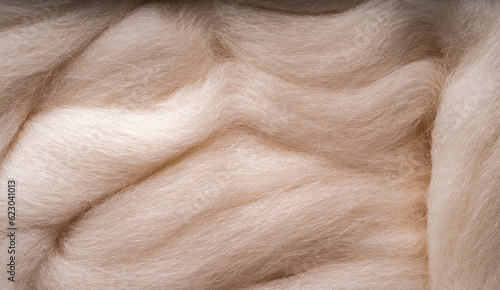 White merino wool for felting as background. Merino wool for felting and needlework, hobby. photo