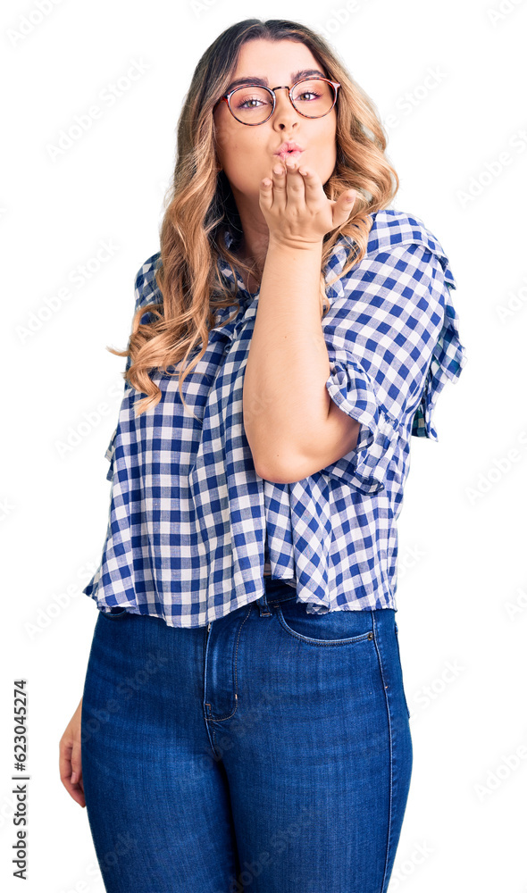 Young caucasian woman wearing casual clothes looking at the camera blowing a kiss with hand on air being lovely and sexy. love expression. Young caucasian woman wearing casual clothes looking at the camera blowing a kiss with hand on air being lovely and sexy. love expression.