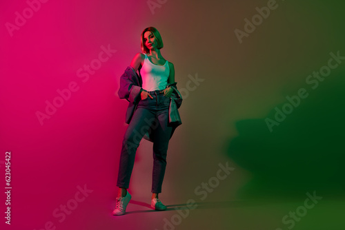 Full body photo of youngster lady standing posing advertise denim clothes garment isolated vibrant neon color background