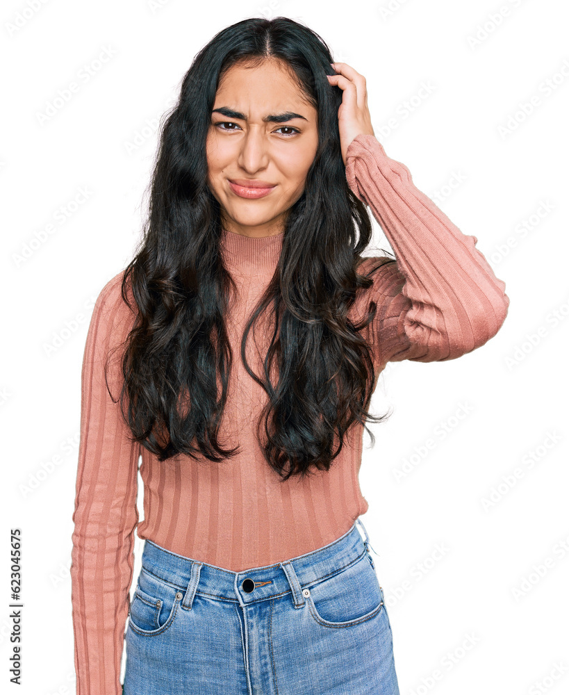 Fototapeta premium Hispanic teenager girl with dental braces wearing casual clothes confuse and wonder about question. uncertain with doubt, thinking with hand on head. pensive concept.