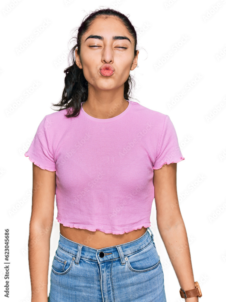 Obraz premium Hispanic teenager girl with dental braces wearing casual clothes looking at the camera blowing a kiss on air being lovely and sexy. love expression.