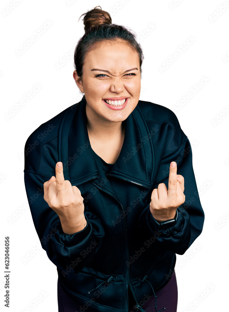 Young hispanic girl wearing sportswear showing middle finger doing fuck you bad expression, provocation and rude attitude. screaming excited Young hispanic girl wearing sportswear showing middle finger doing fuck you bad expression, provocation and rude attitude. screaming excited