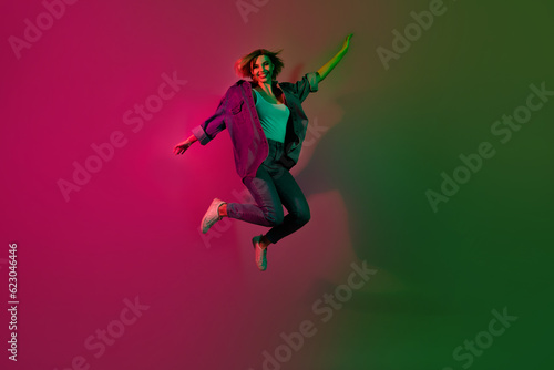 Full size photo of cheerful lady enjoy weekend clubbing in futuristic nightclub isolated on vivid neon color background