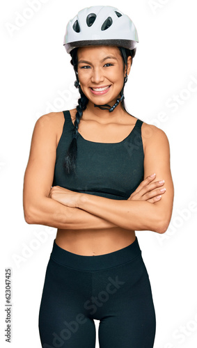 Beautiful hispanic woman wearing bike helmet happy face smiling with crossed arms looking at the camera. positive person. © Krakenimages.com