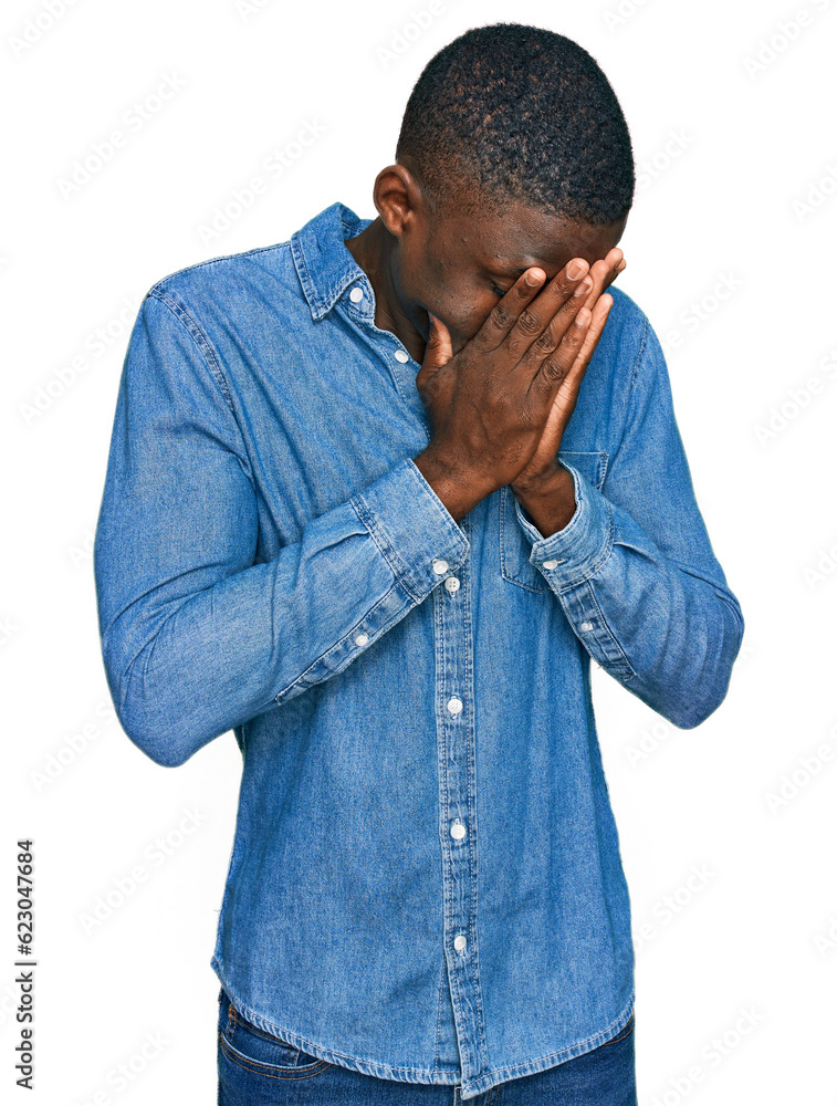 Young african american man wearing casual clothes with sad expression covering face with hands while crying. depression concept.