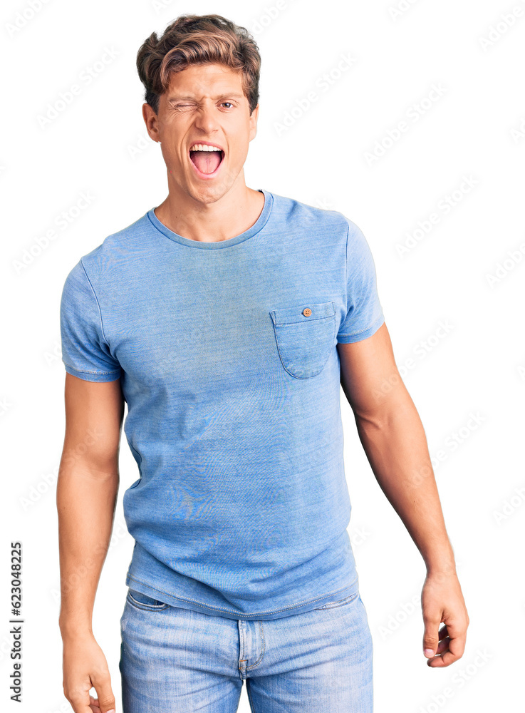 Young handsome man wearing casual clothes winking looking at the camera with sexy expression, cheerful and happy face. Young handsome man wearing casual clothes winking looking at the camera with sexy expression, cheerful and happy face.