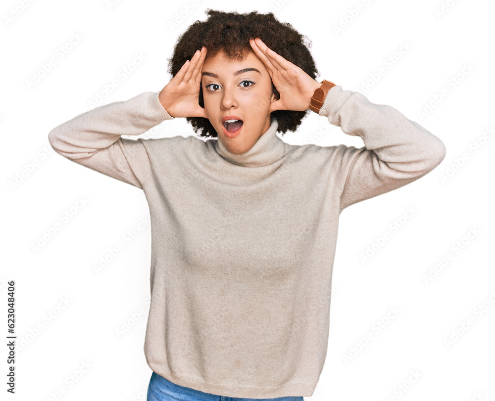 Young hispanic girl wearing wool winter sweater smiling cheerful playing peek a boo with hands showing face. surprised and exited Young hispanic girl wearing wool winter sweater smiling cheerful playing peek a boo with hands showing face. surprised and exited