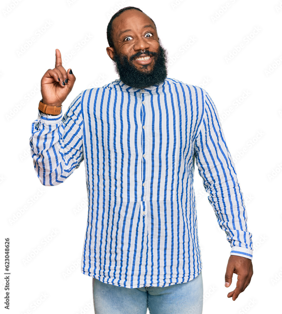 Young african american man wearing business shirt pointing finger up with successful idea. exited and happy. number one. Young african american man wearing business shirt pointing finger up with successful idea. exited and happy. number one.