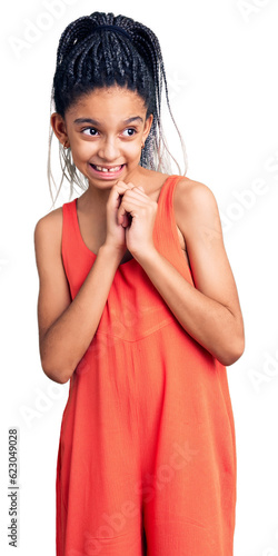 Cute african american girl wearing casual clothes laughing nervous and excited with hands on chin looking to the side