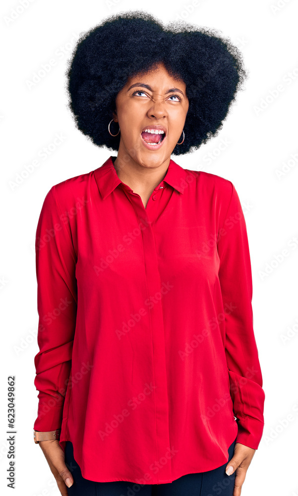 Young african american girl wearing casual clothes angry and mad screaming frustrated and furious, shouting with anger. rage and aggressive concept. Young african american girl wearing casual clothes angry and mad screaming frustrated and furious, shouting with anger. rage and aggressive concept.