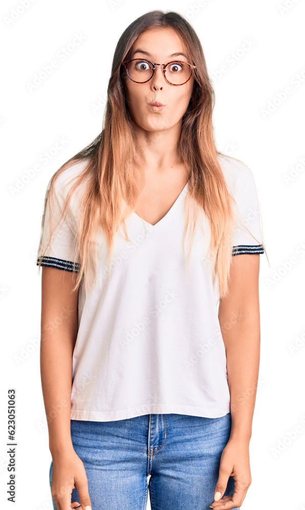 Beautiful caucasian woman wearing casual clothes and glasses smiling happy pointing with hand and finger Beautiful caucasian woman wearing casual clothes and glasses smiling happy pointing with hand and finger