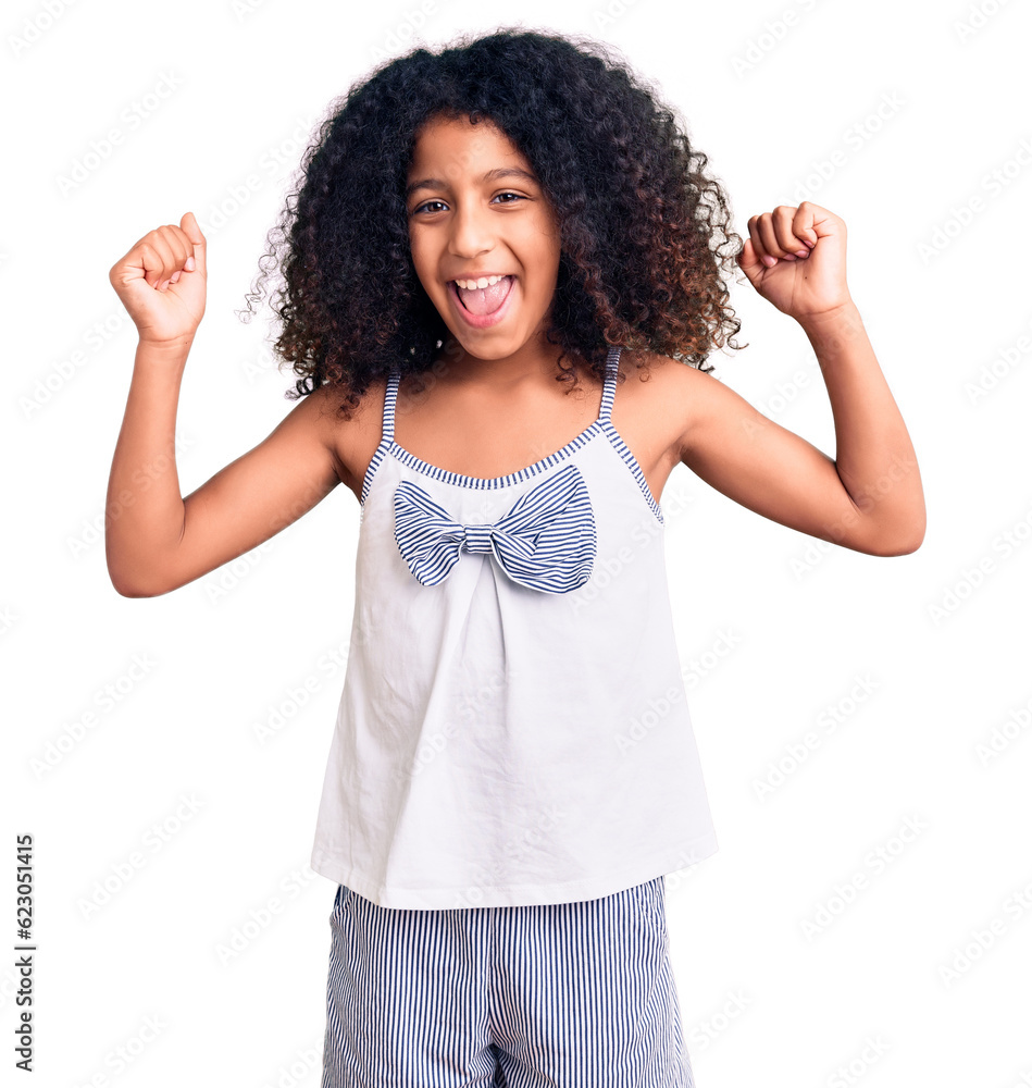 African american child with curly hair wearing casual clothes screaming proud, celebrating victory and success very excited with raised arms African american child with curly hair wearing casual clothes screaming proud, celebrating victory and success very excited with raised arms