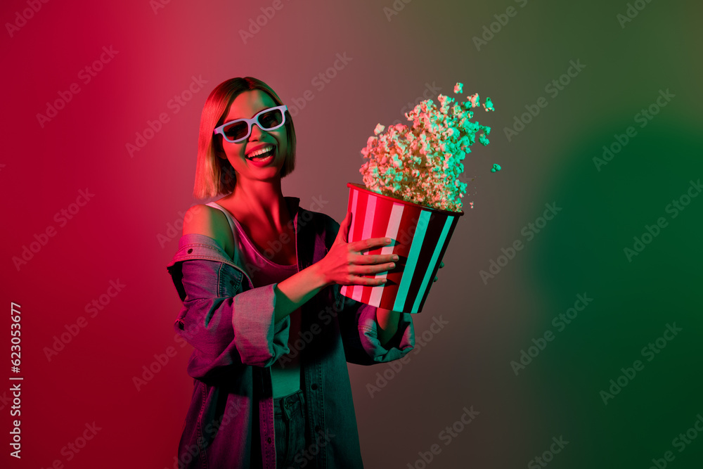 Photo of positive excited lady have free time enjoy watching film in cinema throw pop corn bucket isolated neon colorful background Photo of positive excited lady have free time enjoy watching film in cinema throw pop corn bucket isolated neon colorful background
