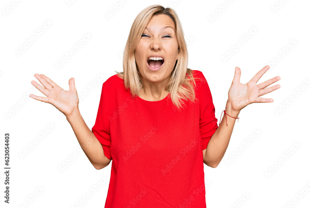 Middle age caucasian woman wearing casual clothes crazy and mad shouting and yelling with aggressive expression and arms raised. frustration concept. Middle age caucasian woman wearing casual clothes crazy and mad shouting and yelling with aggressive expression and arms raised. frustration concept.