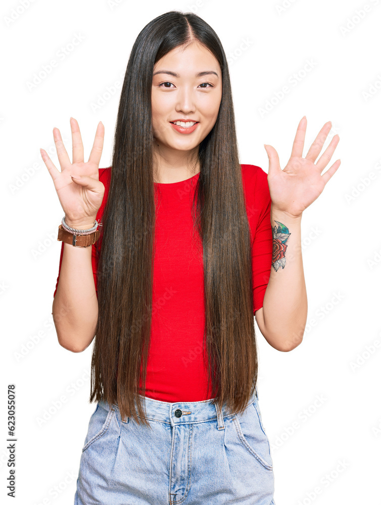 Young chinese woman wearing casual clothes showing and pointing up with fingers number nine while smiling confident and happy. Young chinese woman wearing casual clothes showing and pointing up with fingers number nine while smiling confident and happy.