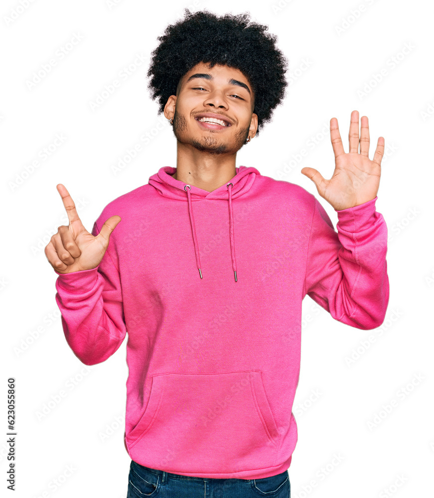 Young african american man with afro hair wearing casual pink sweatshirt showing and pointing up with fingers number seven while smiling confident and happy. Young african american man with afro hair wearing casual pink sweatshirt showing and pointing up with fingers number seven while smiling confident and happy.