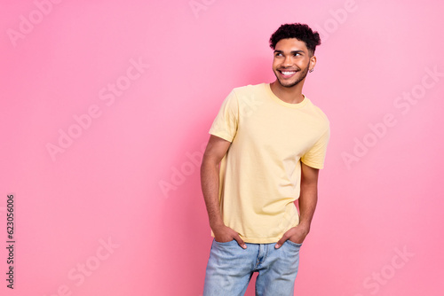 Photo portrait of young attractive multiethnic guy model look side empty space wear shirt isolated pink color background © deagreez