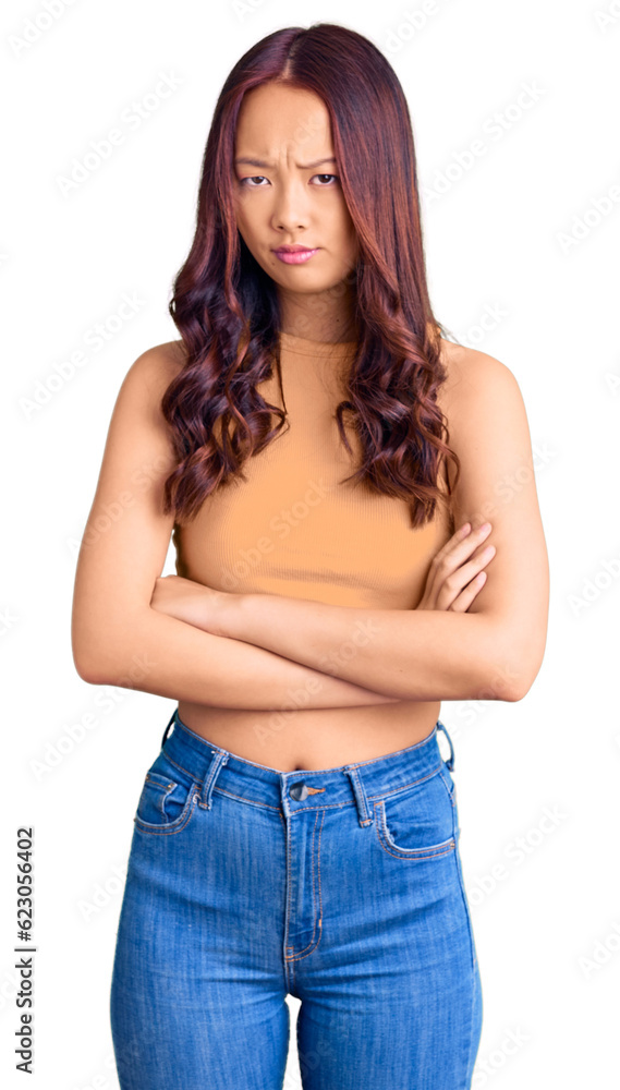 Young beautiful chinese girl wearing casual clothes skeptic and nervous, disapproving expression on face with crossed arms. negative person. Young beautiful chinese girl wearing casual clothes skeptic and nervous, disapproving expression on face with crossed arms. negative person.