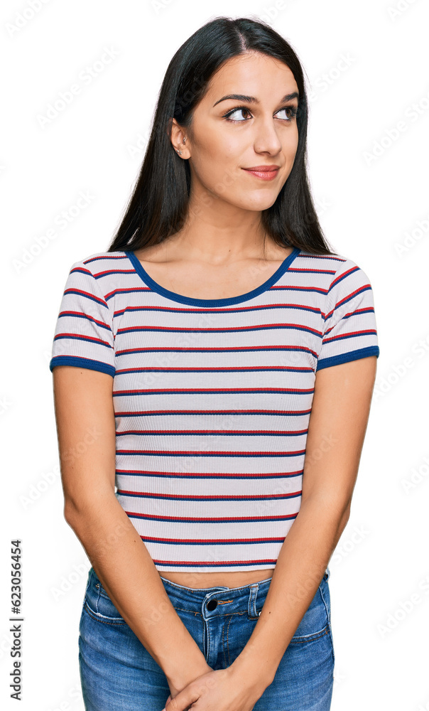 Young hispanic girl wearing casual striped t shirt smiling looking to the side and staring away thinking. Young hispanic girl wearing casual striped t shirt smiling looking to the side and staring away thinking.