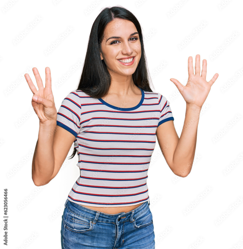 Young hispanic girl wearing casual striped t shirt showing and pointing up with fingers number eight while smiling confident and happy. Young hispanic girl wearing casual striped t shirt showing and pointing up with fingers number eight while smiling confident and happy.
