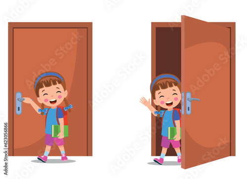 little kid standing and holding door knob