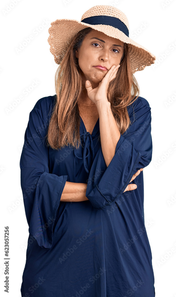 Fototapeta premium Middle age hispanic woman wearing summer hat thinking looking tired and bored with depression problems with crossed arms.