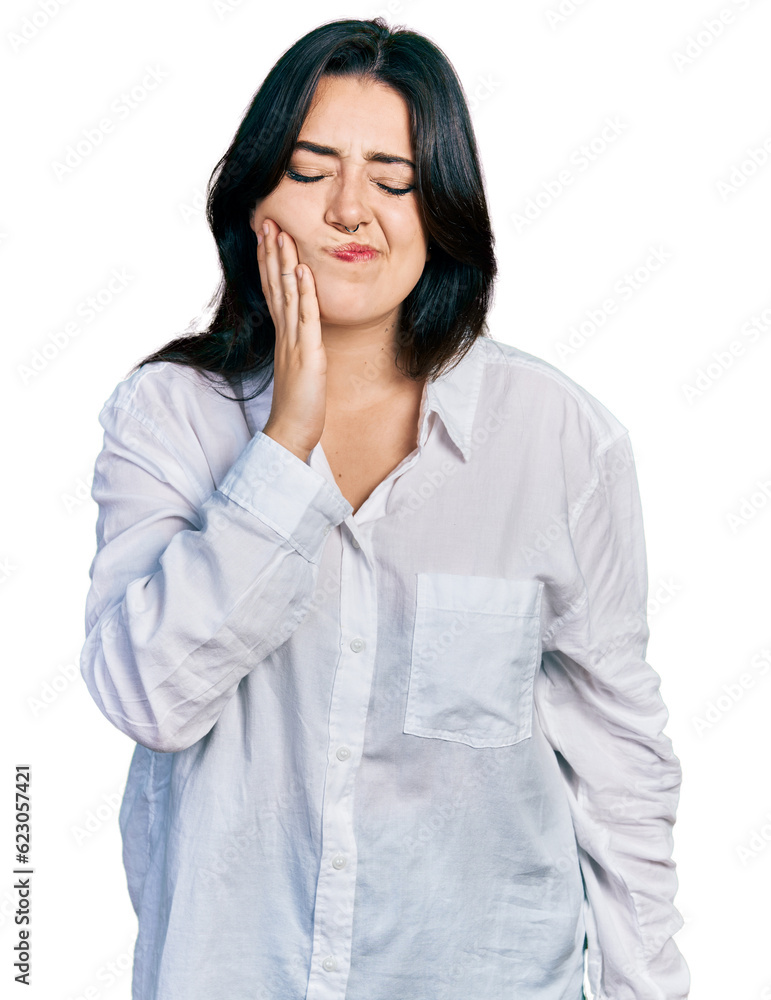 Beautiful hispanic woman wearing casual white shirt touching mouth with hand with painful expression because of toothache or dental illness on teeth. dentist Beautiful hispanic woman wearing casual white shirt touching mouth with hand with painful expression because of toothache or dental illness on teeth. dentist